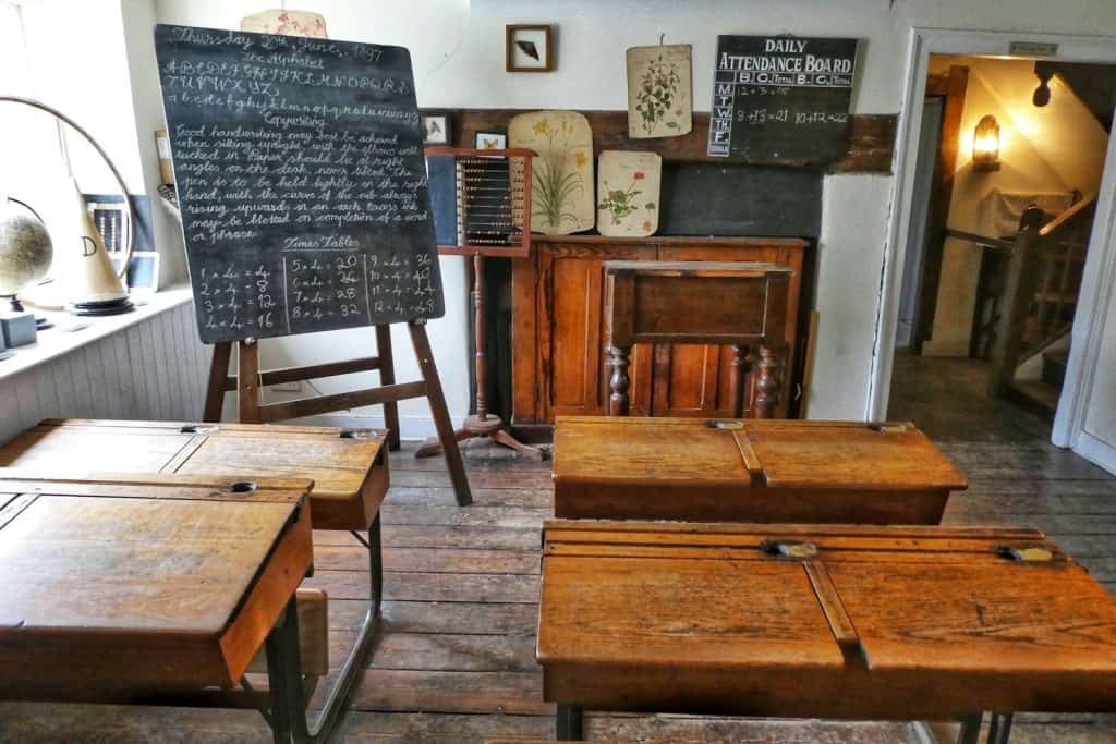 four brown desks inside room