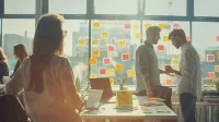 Diverse team in a modern office engaged in a focused Scrum meeting with sticky notes.