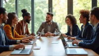 Professionals engaged in a team meeting around a large wooden table with laptops and notepads.